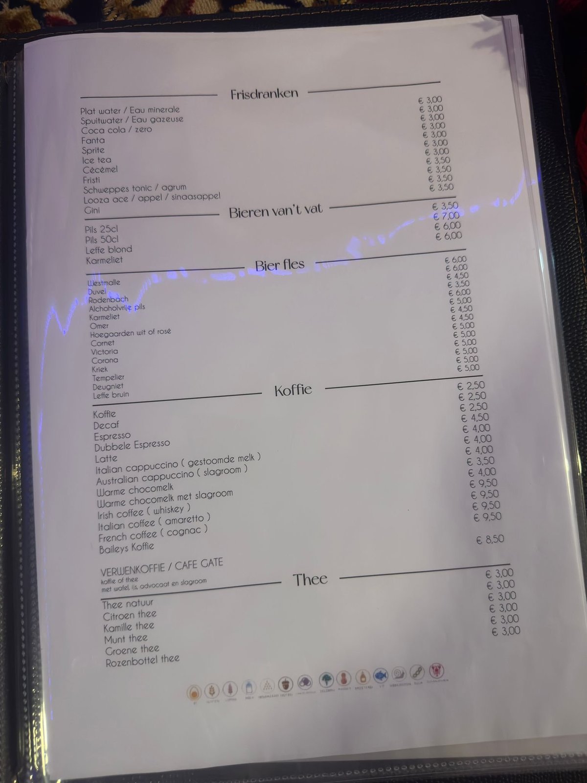 Dutch cafe menu with sections for soft drinks, beer, coffee, and tea with prices listed in euros